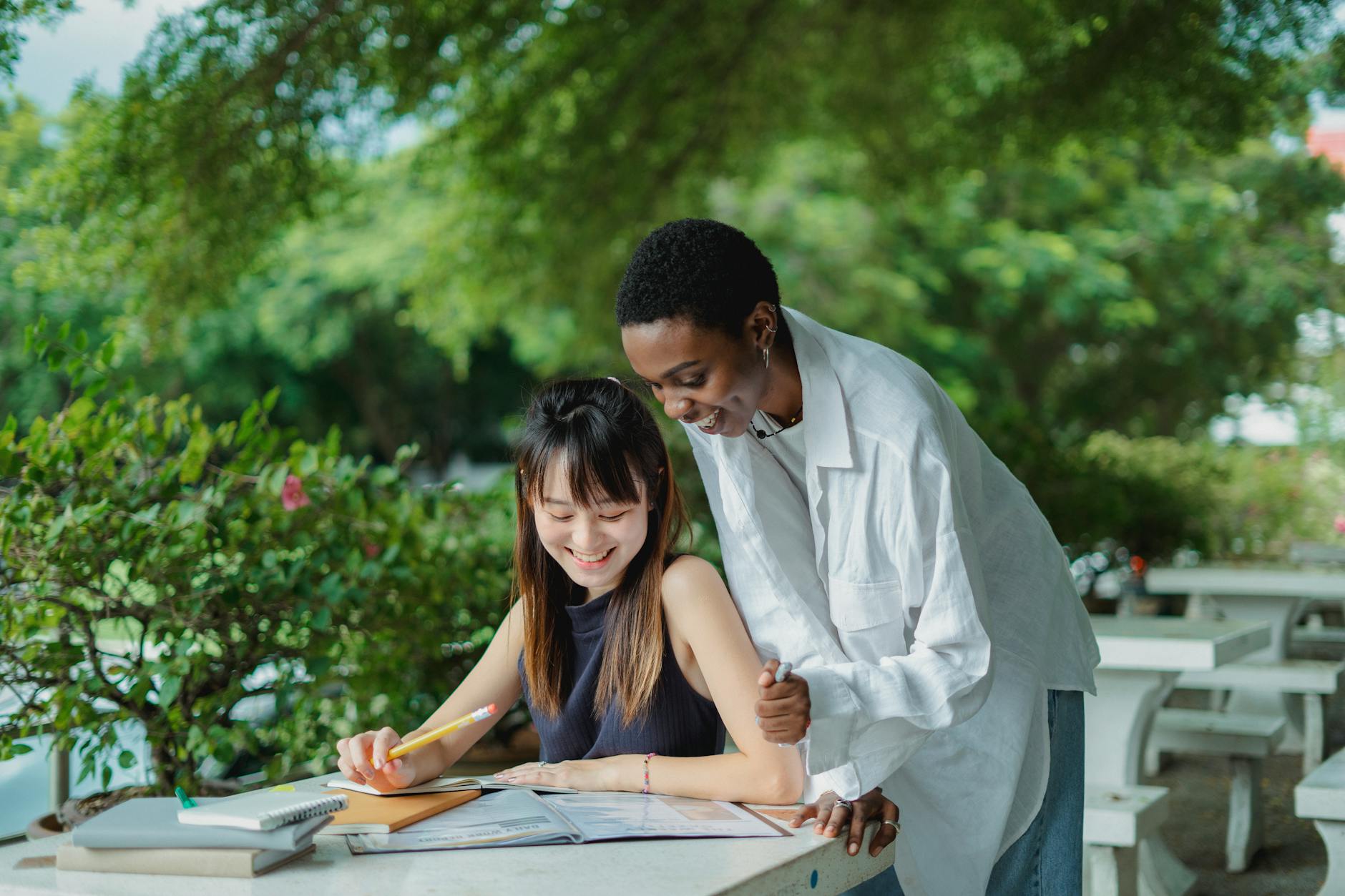 multiracial female friends preparing for exam outside